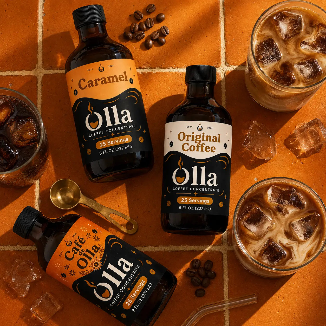Olla coffee concentrates with three prepared iced coffee drinks on warm clay tile